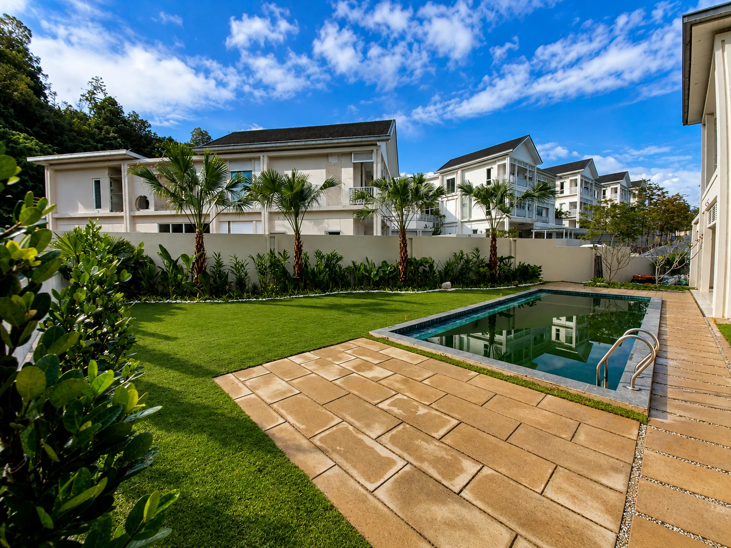 Completed residential landscape at Serene Mont Kiara showing garden, poolside planting and the home setting